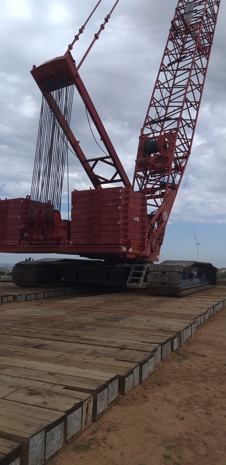 Eucalyptus heavy lift timber mats supporting crawler crane during critical lift on wind project
